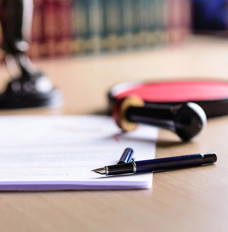 A pen and paper on top of a table.